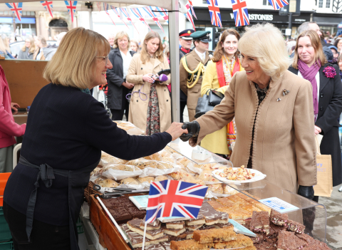 Queen Camilla meets a trader during a visit to the Farmers' Market in The Square, Shrewsbury, in Shropshire.